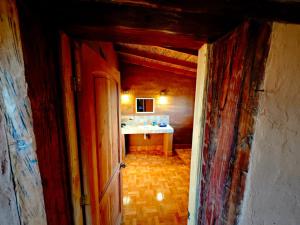 a hallway of a bathroom with a sink at CkuriQuechuaexperience in San Pedro de Atacama +9 photos