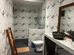 a bathroom with a sink and a toilet at Sayang Bungalows in Kuta Lombok