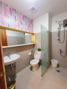a bathroom with a toilet and a sink and a shower at MesaCondo Studio with Balcony in Davao City
