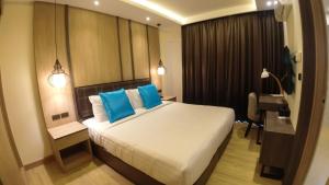 Postel nebo postele na pokoji v ubytování Wyatt Hotel Jomtien Beach