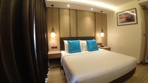 Postel nebo postele na pokoji v ubytování Wyatt Hotel Jomtien Beach