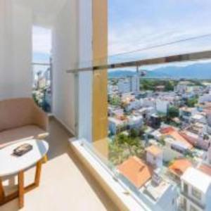 a room with a view of a city from a window at Astica Hotel Nha trang in Nha Trang