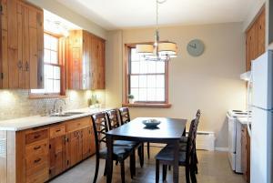 a kitchen with a table and chairs and a sink at 930R-B1 The Old House in Quebec City