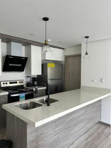 a kitchen with a sink and a counter top at Spectacular mountain views at San Pedro Sula in San Pedro Sula