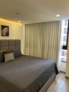 a bedroom with a large bed and a window at Spectacular mountain views at San Pedro Sula in San Pedro Sula