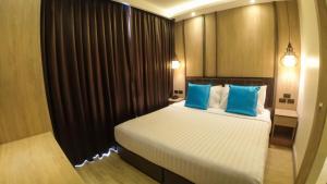 Postel nebo postele na pokoji v ubytování Wyatt Hotel Jomtien Beach