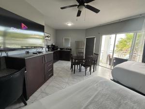 a bedroom with a bed and a kitchen with a table at Grace Bay Suites in Grace Bay