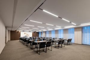 a large room with tables and chairs in it at Atour Hotel Hangzhou Binjiang Yuanlun Building in Hangzhou