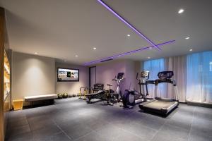 a gym with treadmills and exercise equipment in a room at Atour Hotel Hangzhou Binjiang Yuanlun Building in Hangzhou