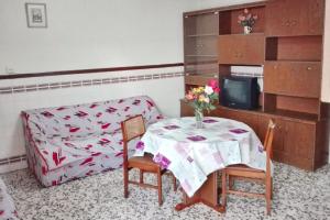 a living room with a table and a couch at Spacious apartment with balcony - Guardamar del Segura - 100 m² in Guardamar del Segura +10 photos