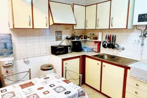 a small kitchen with white cabinets and a sink at Welcoming House with Sea View in Corme-Porto in Corme-Puerto