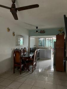 a kitchen with a table and chairs in a room at Casa Arboledas in Manzanillo