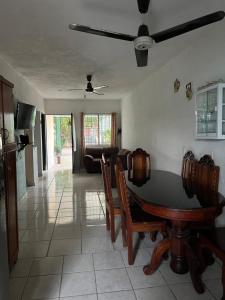 a living room with a table and chairs at Casa Arboledas in Manzanillo