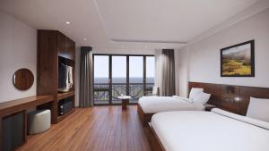 Postel nebo postele na pokoji v ubytování Sapa Warm Hotel