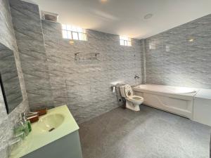 a bathroom with a tub and a toilet and a sink at Guest House Thiên Thanh in Phú Quốc +23 photos