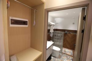 a bathroom with a toilet and a shower at Rainbow holiday resort in Mbuambua Island +65 photos