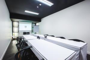 a conference room with a row of tables and chairs at Blu Monkey Hub and Hotel Phuket Town- Free All Day Coworking space in Phuket Town +36 photos