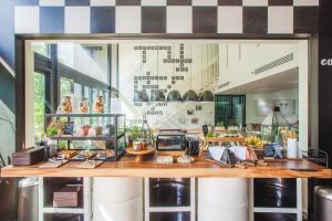a restaurant with a counter with food on it at Blu Monkey Hub and Hotel Phuket Town- Free All Day Coworking space in Phuket Town