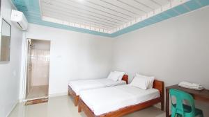 Postel nebo postele na pokoji v ubytování Aloha Guest House Nias