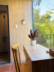 a table and chair with a potted plant on a balcony at Guest House Thiên Thanh in Phu Quoc
