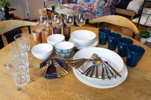 a table with plates and forks and glasses on it at MOMOYA nagomi in Okayama