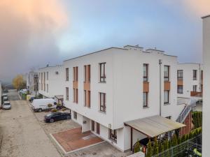 an apartment building under construction on a street at Exclusive townhouse Maciejki with garden and terrace near Warsaw in Nowa Wola