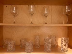 a row of wine glasses sitting on a shelf at My Casitas in Phoenix