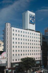 a large white building with a clock on top of it at Hotel Crown Hills Sendai Aobadori in Sendai