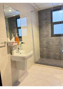 a bathroom with a sink and a shower at 1 - BLUE WORLD - Al Dana Villas in Fujairah