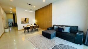 a living room with a couch and a table at Vela house hatyai 2 in Hat Yai