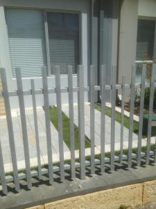 a white picket fence in front of a house at Eden Beach Holiday Getaway in Jindalee