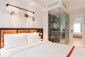 Postel nebo postele na pokoji v ubytování Ruby Stella Hotel London