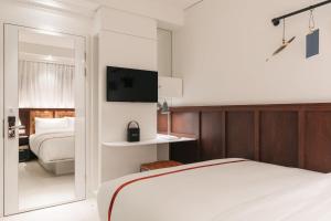 Postel nebo postele na pokoji v ubytování Ruby Stella Hotel London