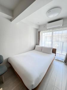 Postel nebo postele na pokoji v ubytování Real Okubo Apartment Hotel
