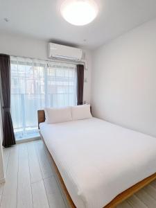 Postel nebo postele na pokoji v ubytování Real Okubo Apartment Hotel + 37 fotografií