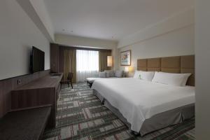 Postel nebo postele na pokoji v ubytování The Howard Plaza Hotel Kaohsiung
