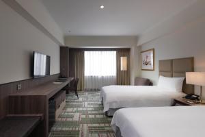 Postel nebo postele na pokoji v ubytování The Howard Plaza Hotel Kaohsiung
