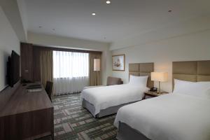 Postel nebo postele na pokoji v ubytování The Howard Plaza Hotel Kaohsiung