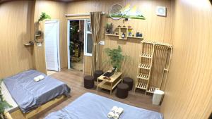 a small room with two beds and a crib at Thien Phu Homestay and Coffee - Mang Den in Kon Von Kla +92 photos