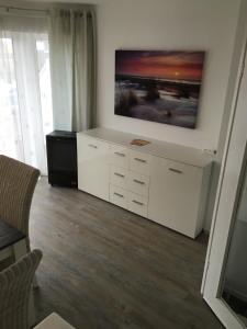 a living room with a tv on a wall at City Marina 78 in Cuxhaven +30 photos