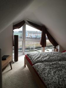 a bedroom with a bed and a large window at City Marina 78 in Cuxhaven