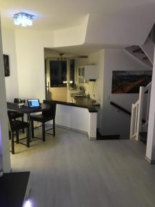a kitchen and dining room with a table and a laptop at City Marina 78 in Cuxhaven