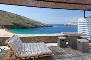 a patio with a view of a beach and the ocean at Coco-Mat Eco Residences Serifos in Vayiá