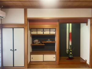 a room with two glass doors and a shelf at 徳治郎の宿 in Izumi-Sano