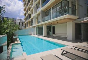 a swimming pool in front of a building at Apartment in Aonang - great location with pool in Ao Nang Beach