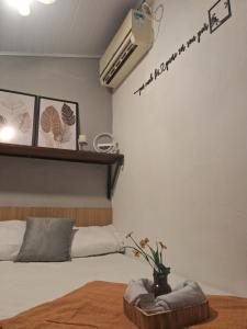 a bedroom with a bed and a air conditioner on the wall at Aconchego Suíte in Prado