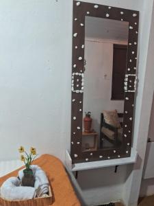 a mirror with polka dots on it on a table at Aconchego Suíte in Prado