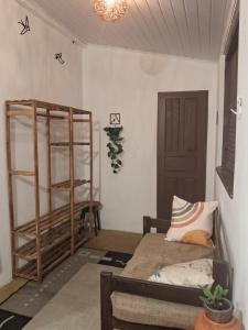 a room with a bed and a book shelf at Aconchego Suíte in Prado