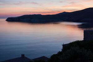 a view of a large body of water at sunset at Coco-Mat Eco Residences Serifos in Vayiá