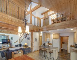 a kitchen and living room with wooden ceilings at Bear Hideaway | Wi-fi, Hot tub, Wood Stove, BBQ in Packwood